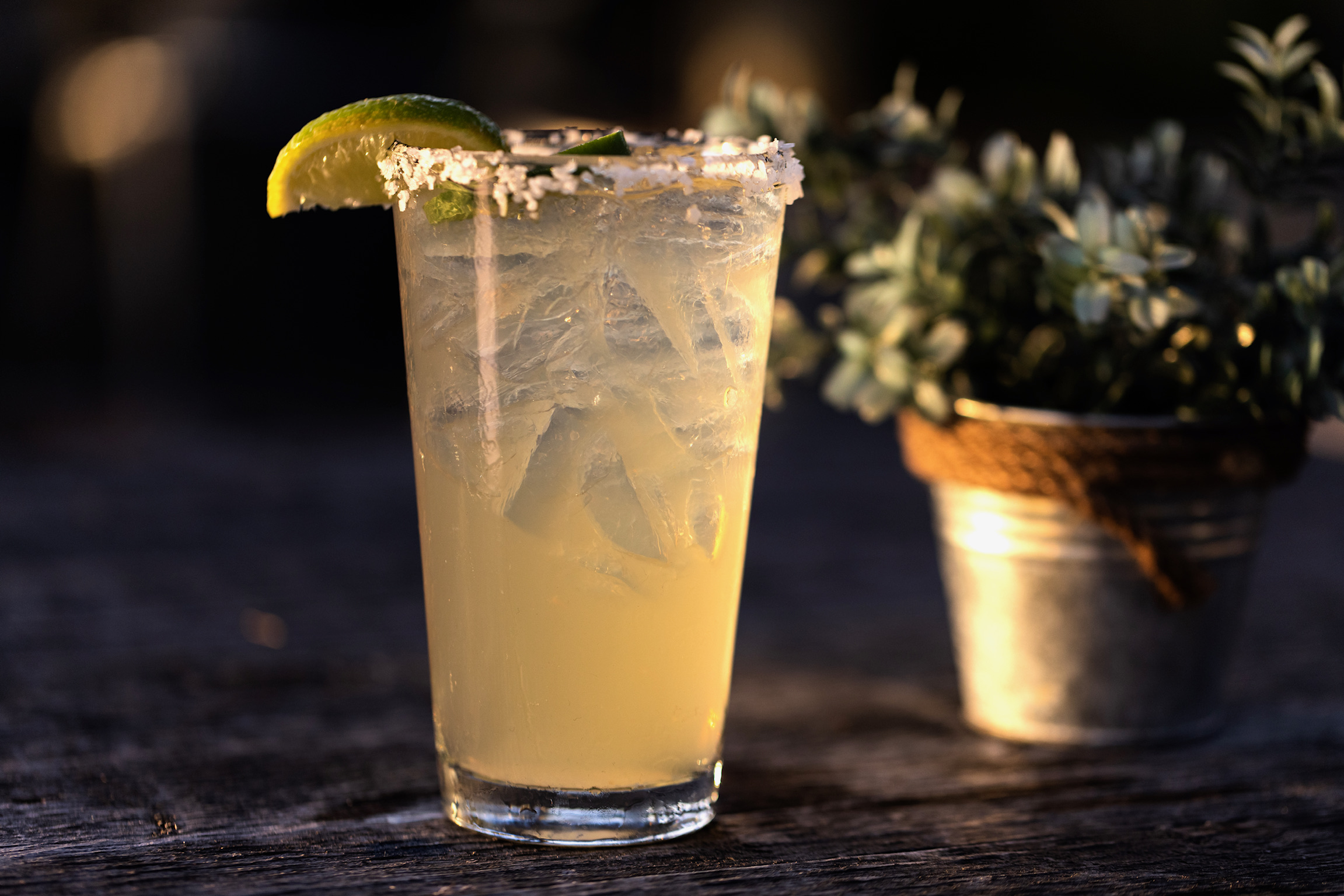 Fresh handcrafted margarita with a salted rim, lime wedge, and jalapeño garnish served over ice at Old Florida Fish House.