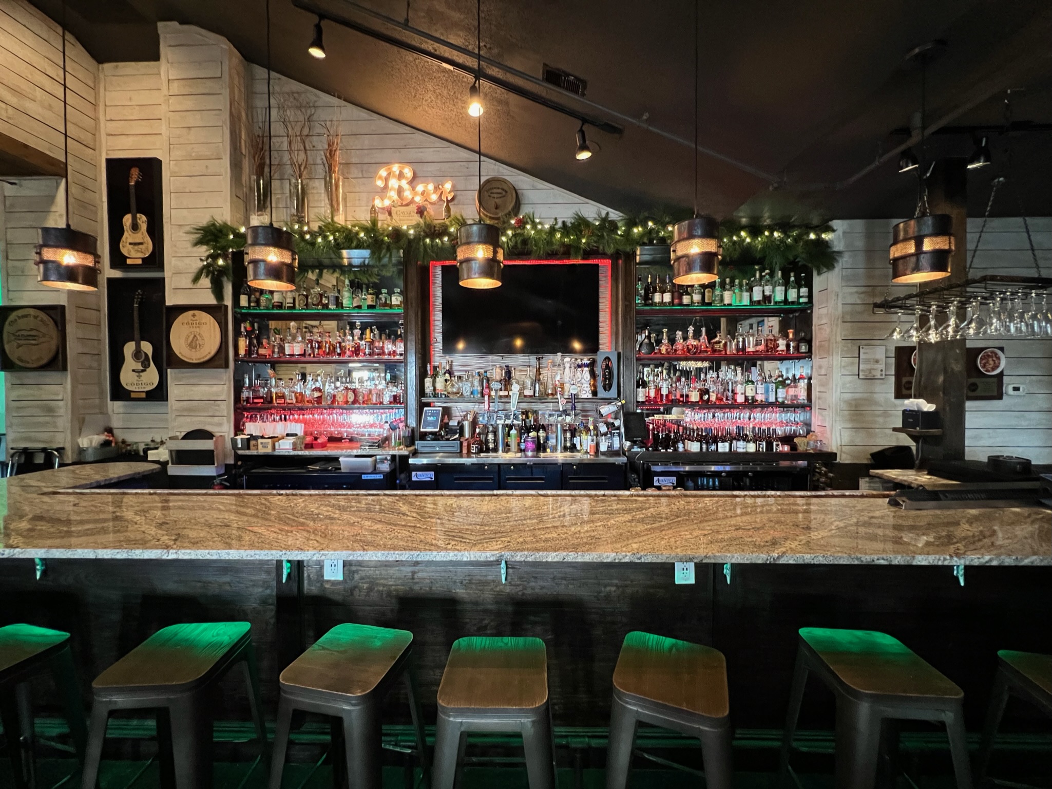 Main bar at Old Florida Fish House featuring a full selection of premium spirits, craft cocktails, and a warm coastal atmosphere.