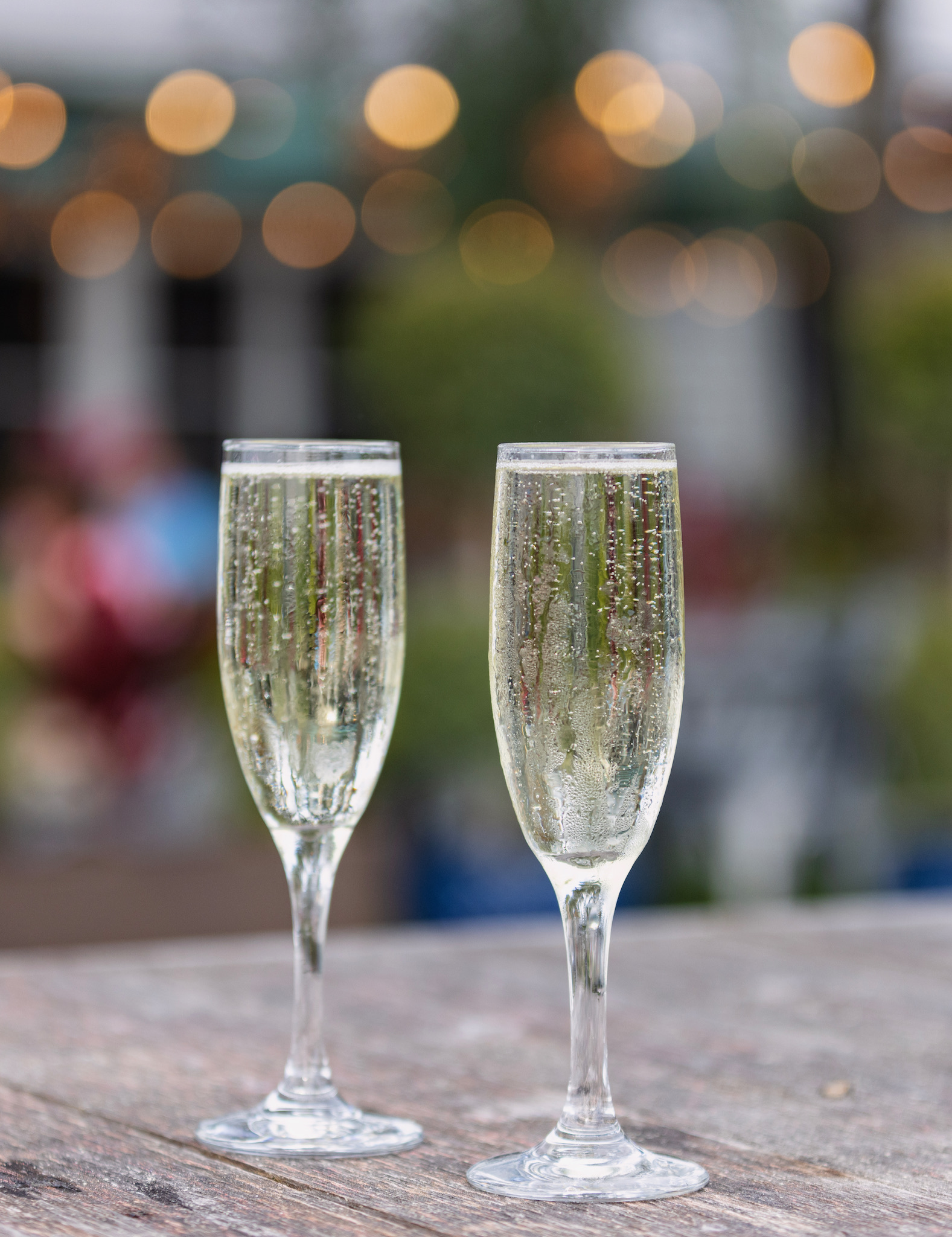 Two chilled champagne flutes with sparkling wine served on the patio at Old Florida Fish House.