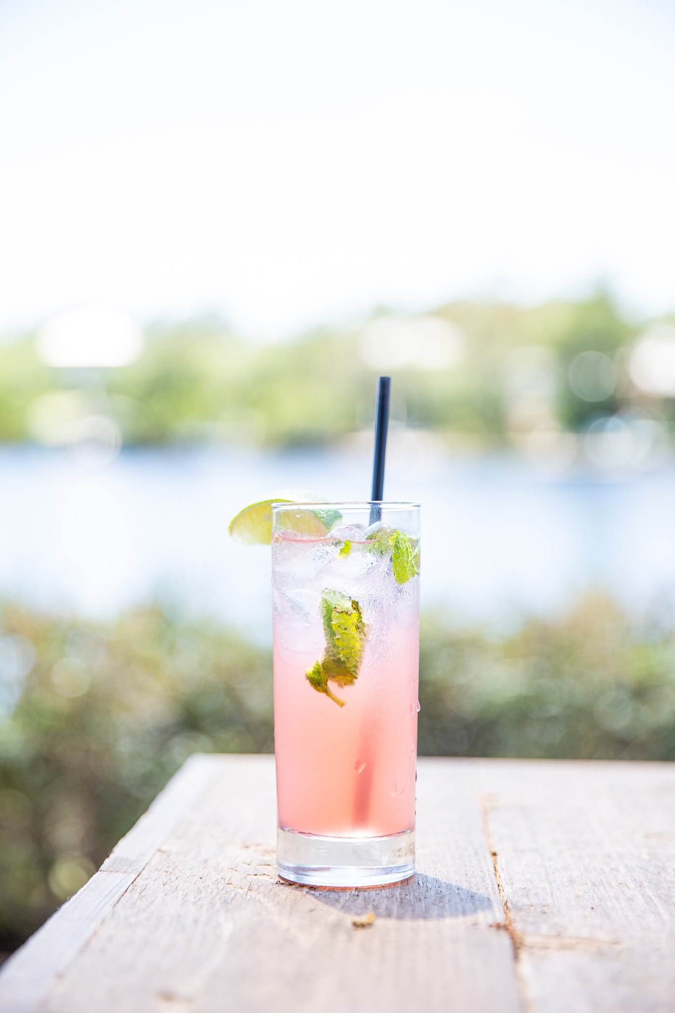 Refreshing pink citrus cocktail with fresh mint, lime, and ice served waterfront at Old Florida Fish House.