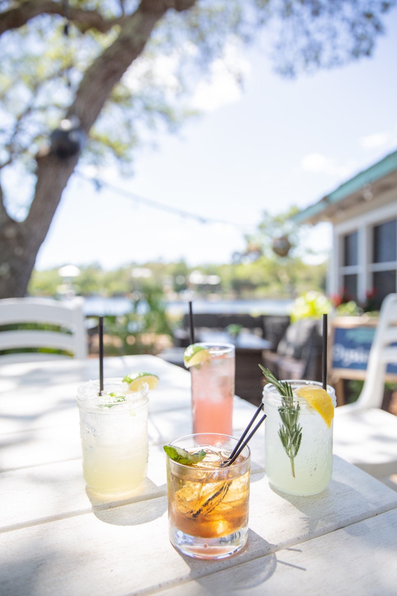 Handcrafted cocktails on the waterfront patio at Old Florida Fish House, featuring margaritas, spritzes, and signature drinks with fresh citrus and herbs.