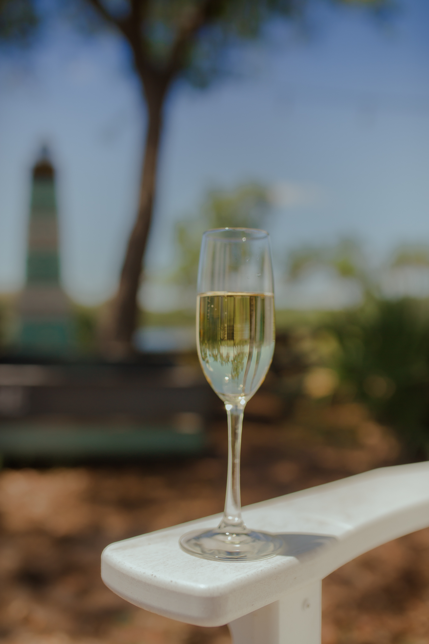 Chilled champagne flute on the waterfront patio at Old Florida Fish House, perfect for celebrating with sparkling wine by the Eastern Lake.